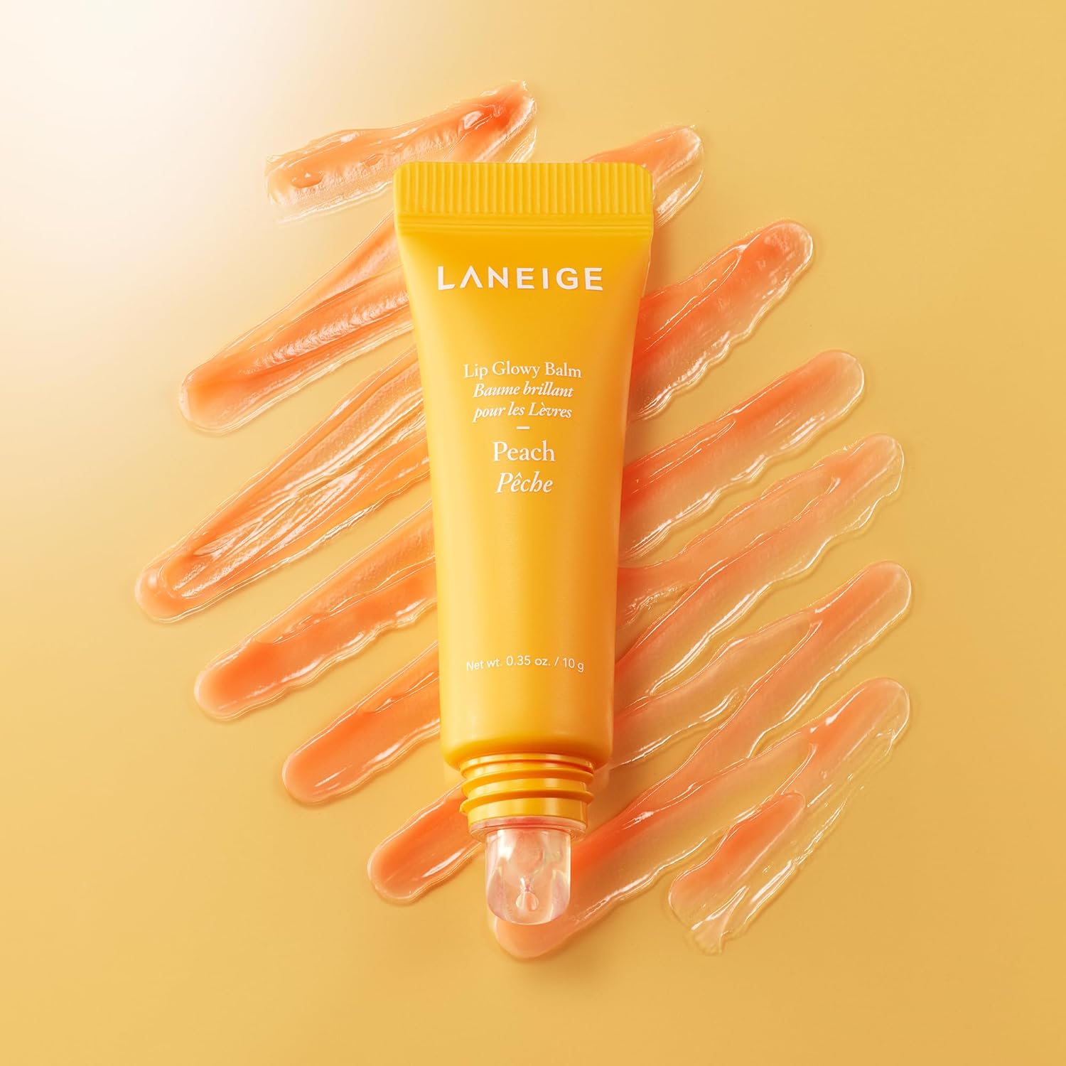 LANEIGE Lip Glowy Balm Peach open jar sheer glossy texture close up
