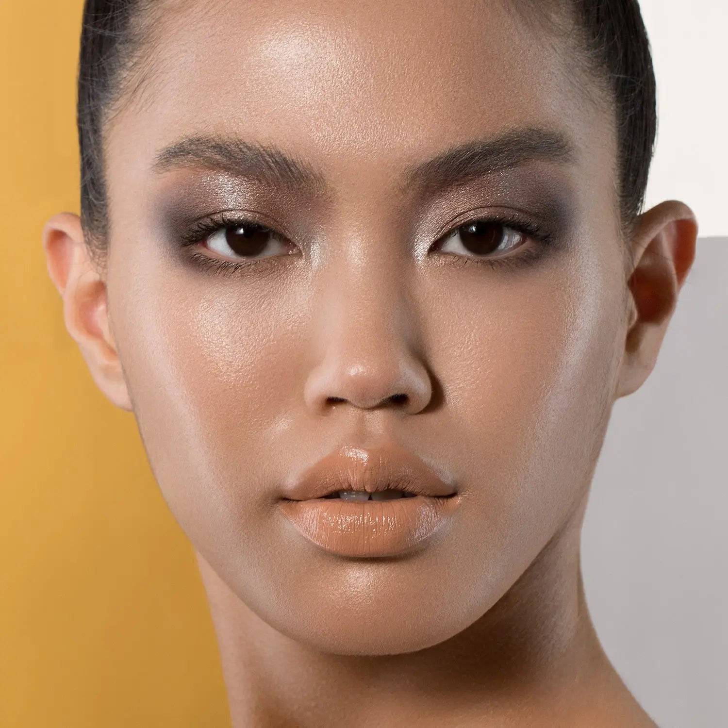 Natasha Denona Super Glow Highlighter model wearing luminous glow on cheekbones