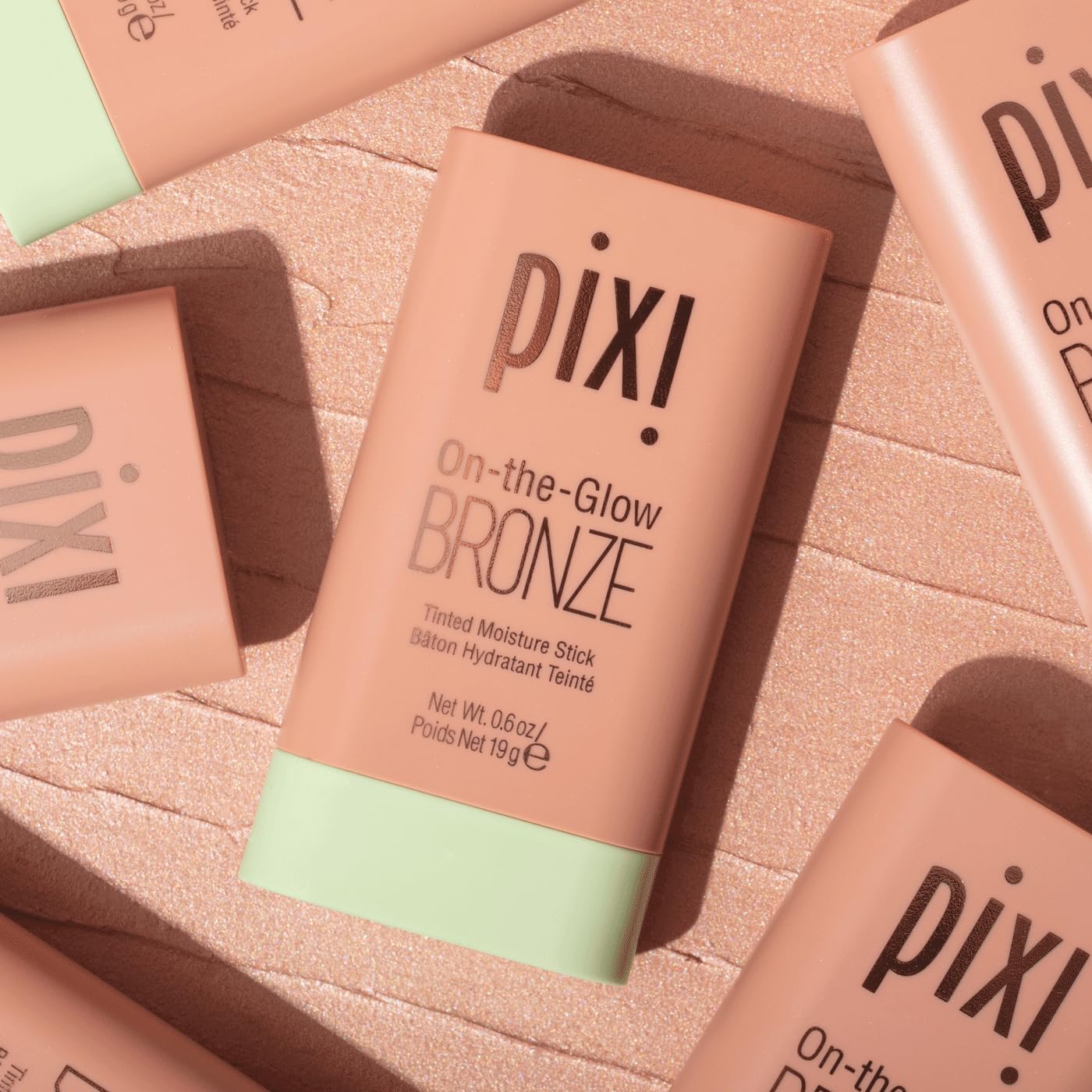 Pixi On-the-Glow Bronze Stick model applying bronzer on cheeks golden glow finish